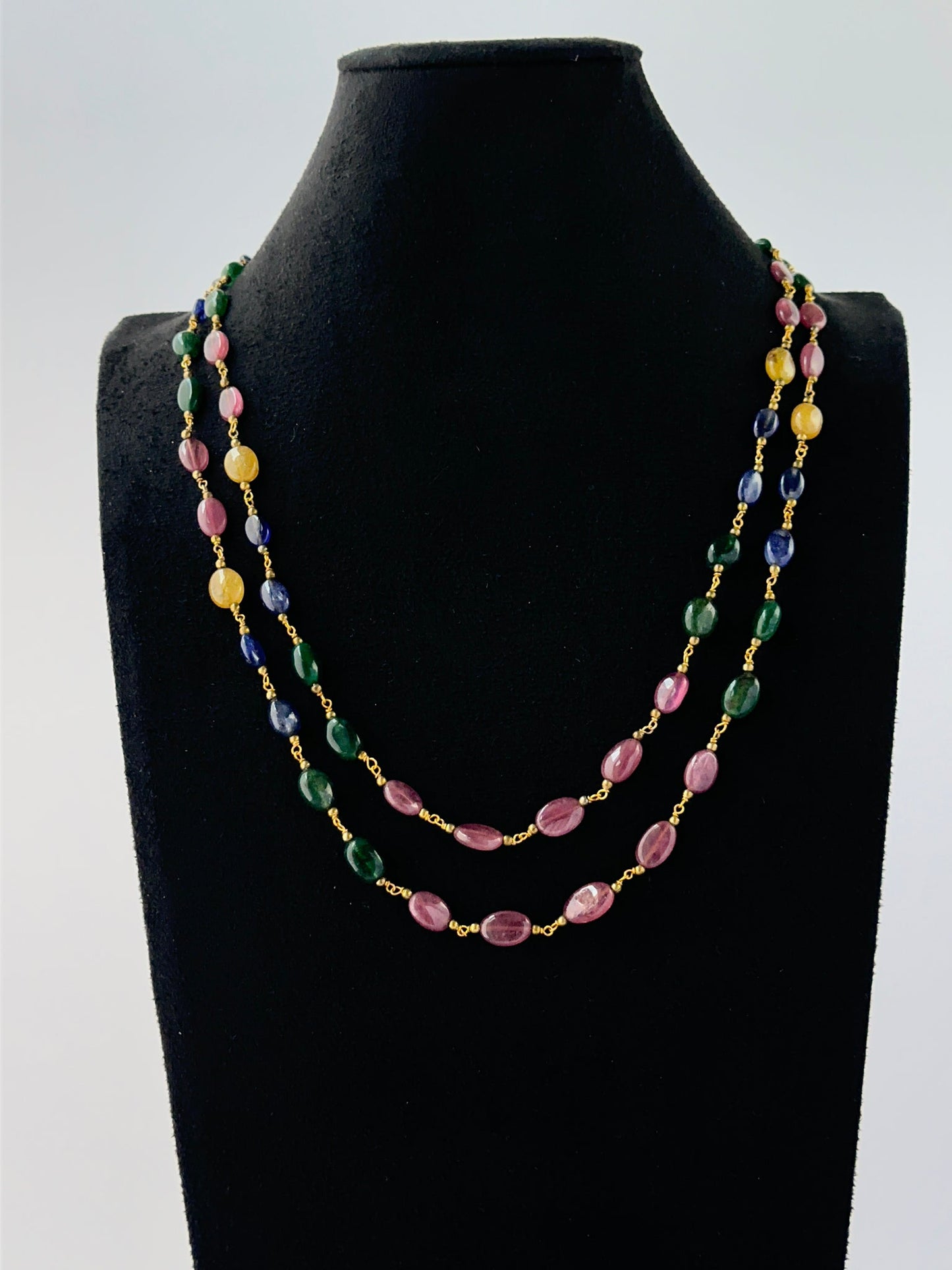 Multi‑gemstone necklace crafted from smooth oval 6–7mm beads in two adjustable strands.