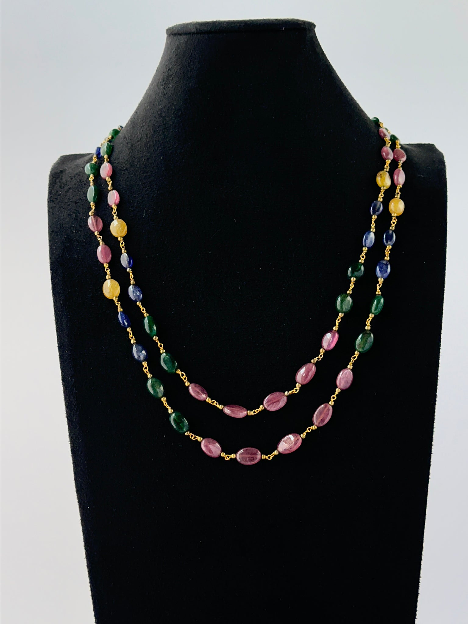 Multi‑gemstone necklace crafted from smooth oval 6–7mm beads in two adjustable strands.