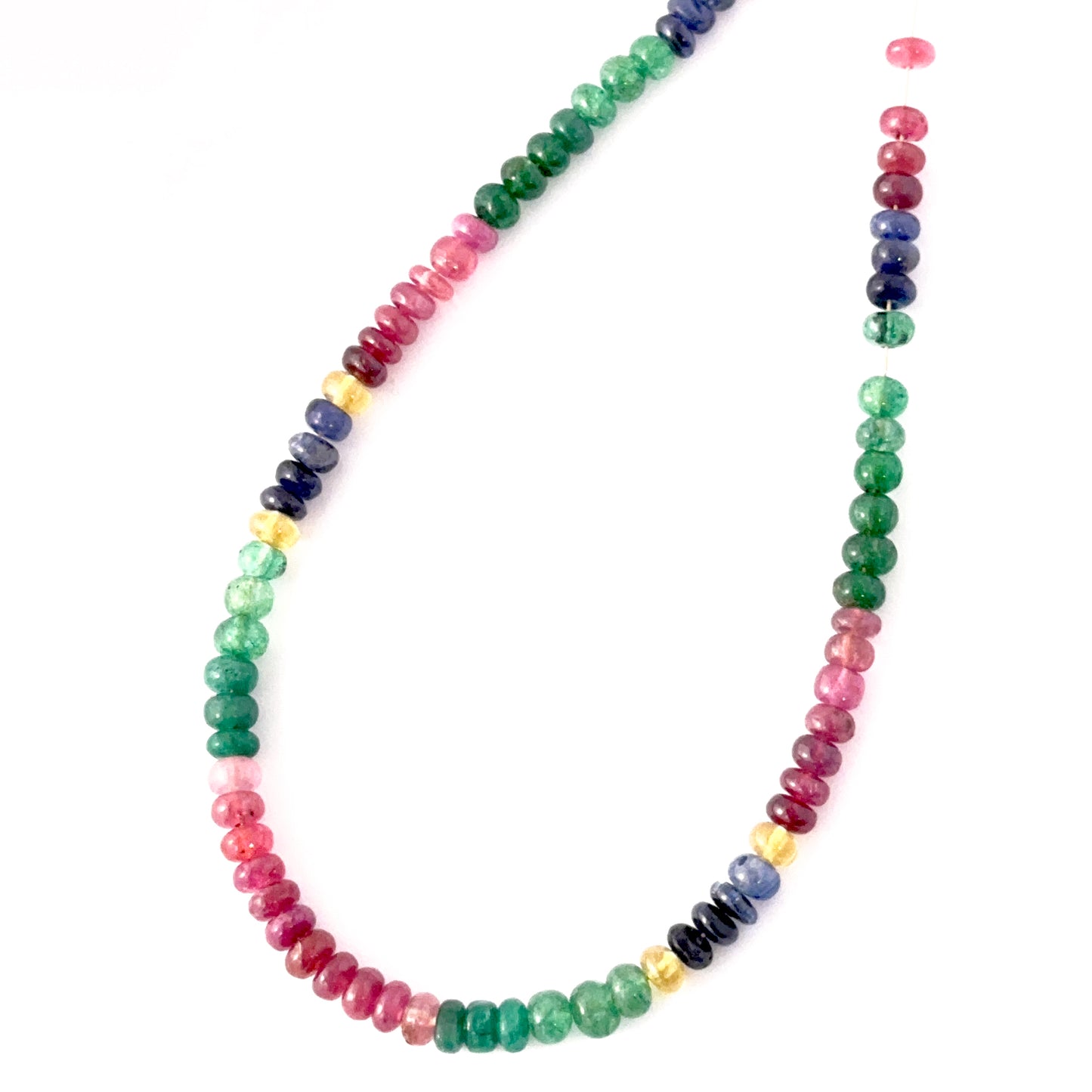 Close‑up of smooth Multi Precious stone beads arranged in a curated polished strand.
