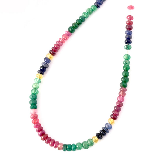 Close‑up of smooth Multi Precious stone beads arranged in a curated polished strand.