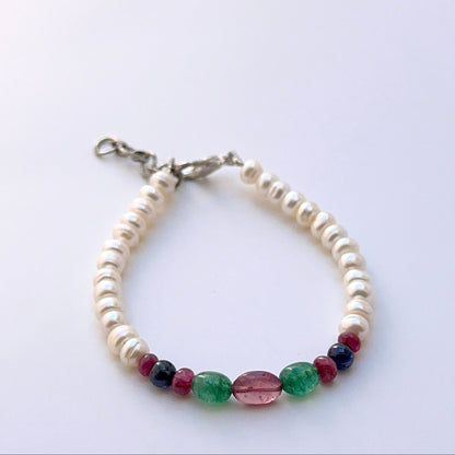 Multi gemstone bracelet with smooth oval beads showing rich colour contrast.