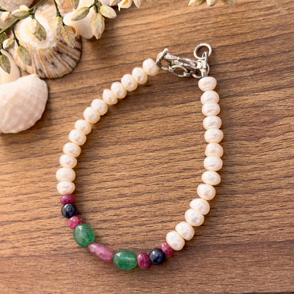 Bracelet featuring smooth oval ruby, emerald, blue sapphire and freshwater pearl beads.