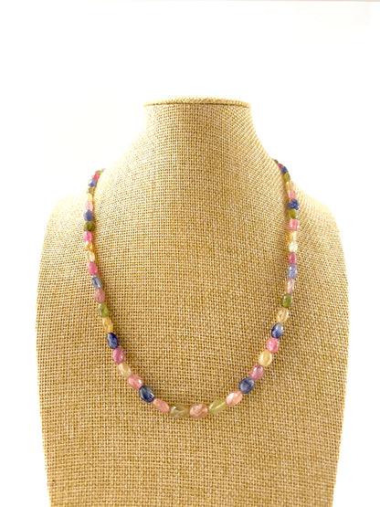 Multi Sapphire necklace with faceted oval 5.5–6.5mm beads arranged in a 50cm adjustable strand, showcasing vibrant mixed sapphire colours.