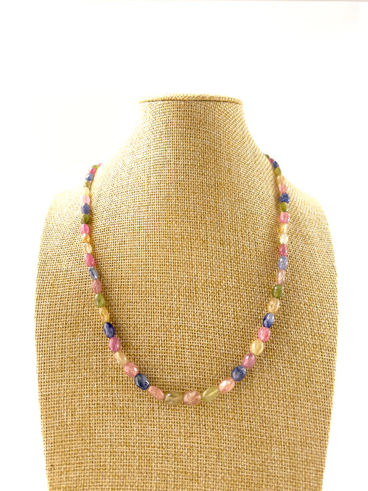 Multi Sapphire necklace with faceted oval 5.5–6.5mm beads arranged in a 50cm adjustable strand, showcasing vibrant mixed sapphire colours.