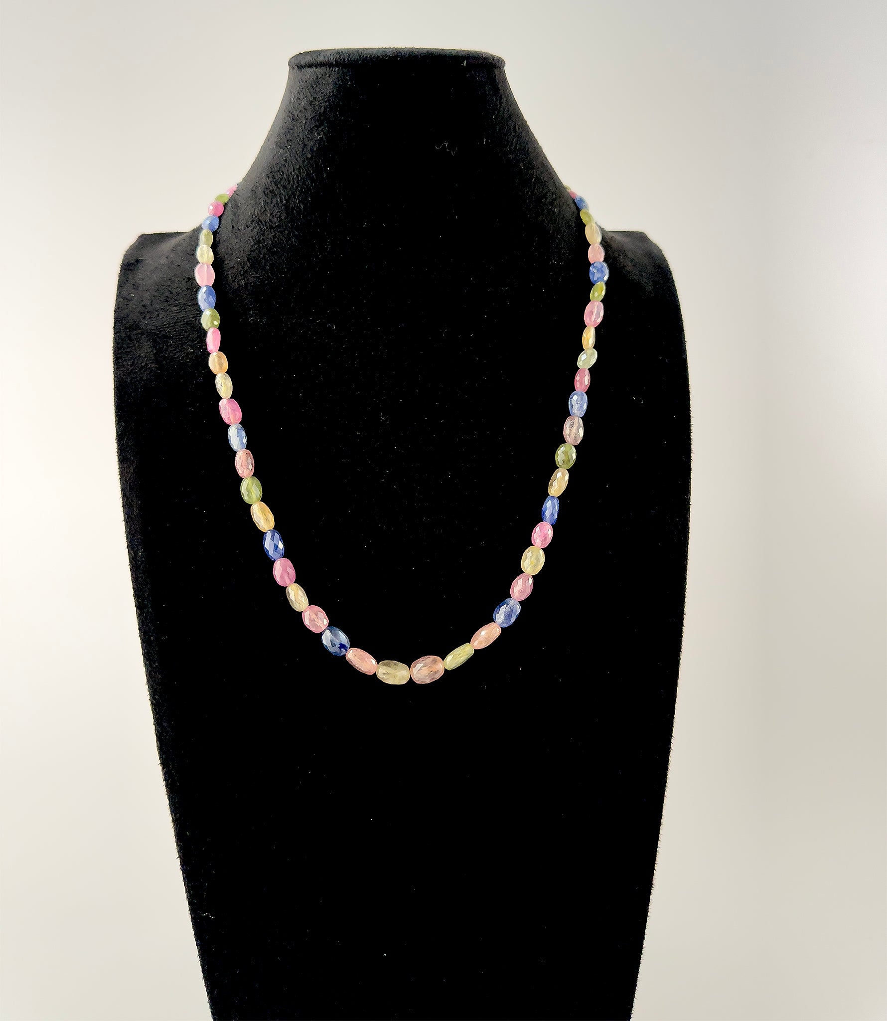 Close‑up of multi Sapphire faceted oval beads highlighting their sparkle, colour depth and polished craftsmanship.