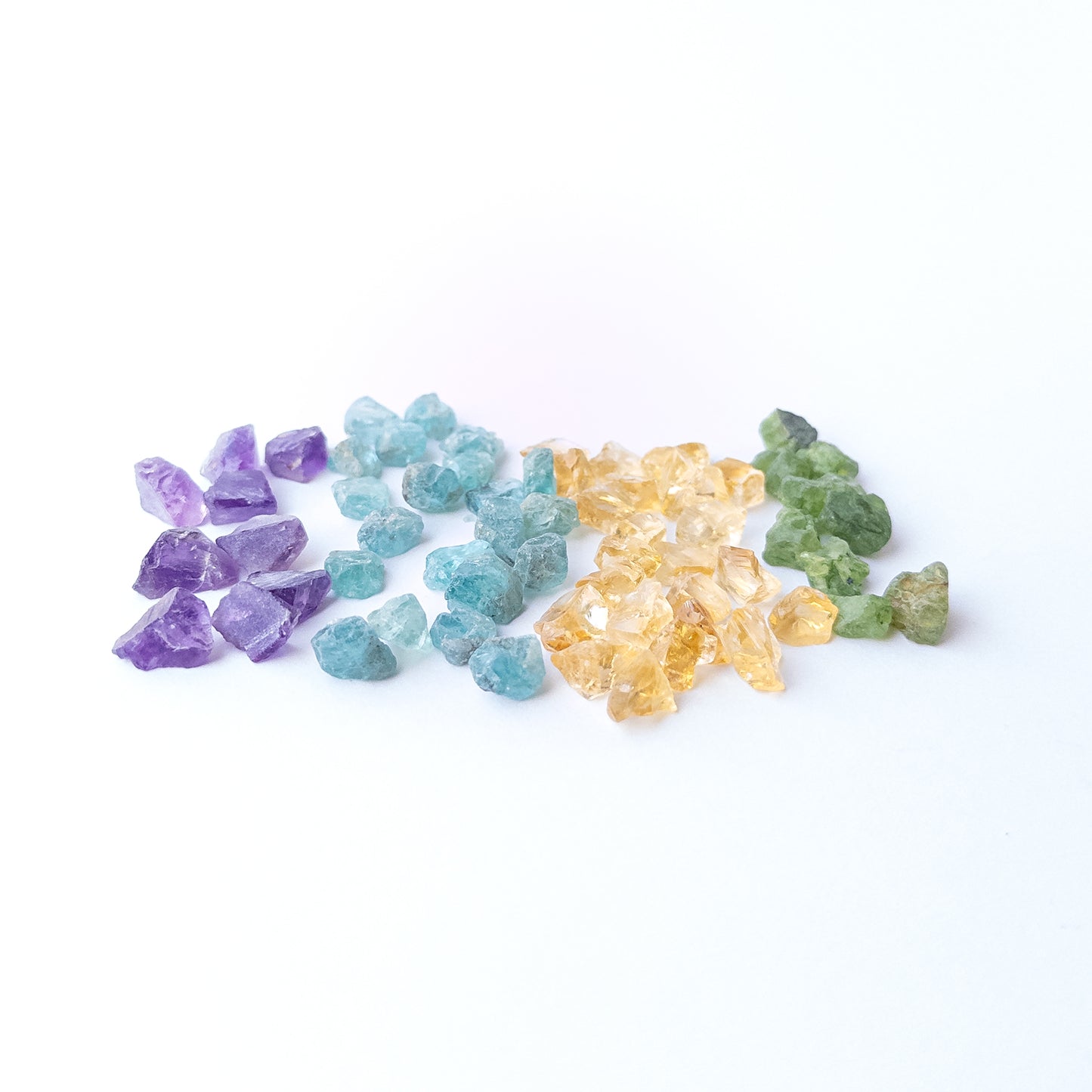 Vibrant Amethyst, Citrine, Apatite and Peridot rough stones with natural sparkle and earthy raw finish.