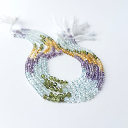 Multi stone smooth round beads of Aquamarine, Citrine, Amethyst and Peridot in 4.5–4.7mm on a 32cm strand.