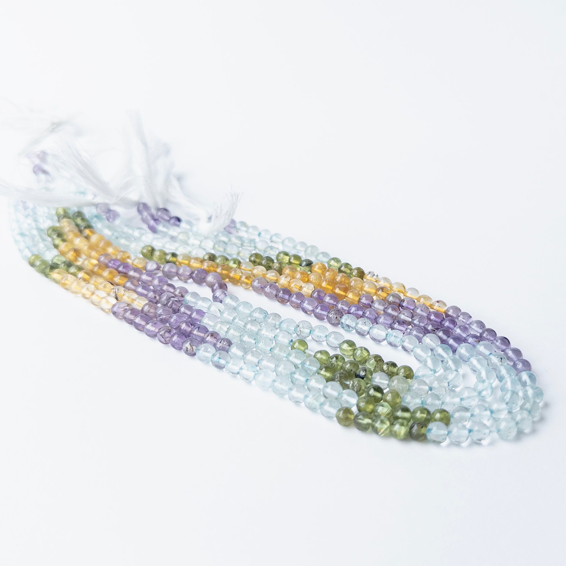 Genuine mixed gemstone beads with polished round finish, ideal for DIY jewellery and handmade components.