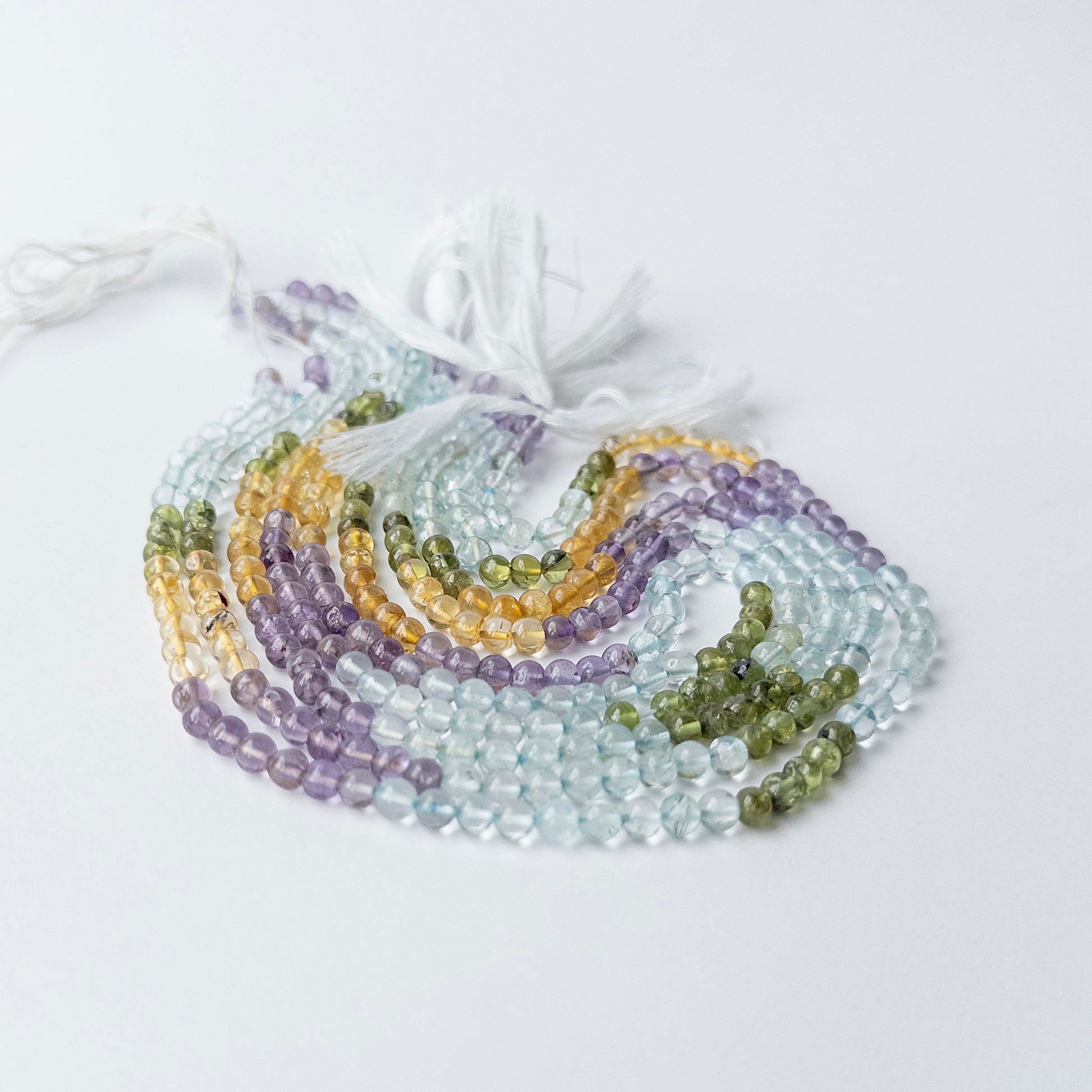 Authentic Aquamarine, Citrine, Amethyst and Peridot beads showing vibrant colours and smooth shine.