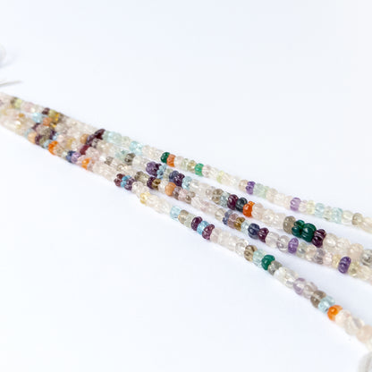 Multi stone carved pumpkin beads arranged on a 20cm strand for handmade jewellery components.