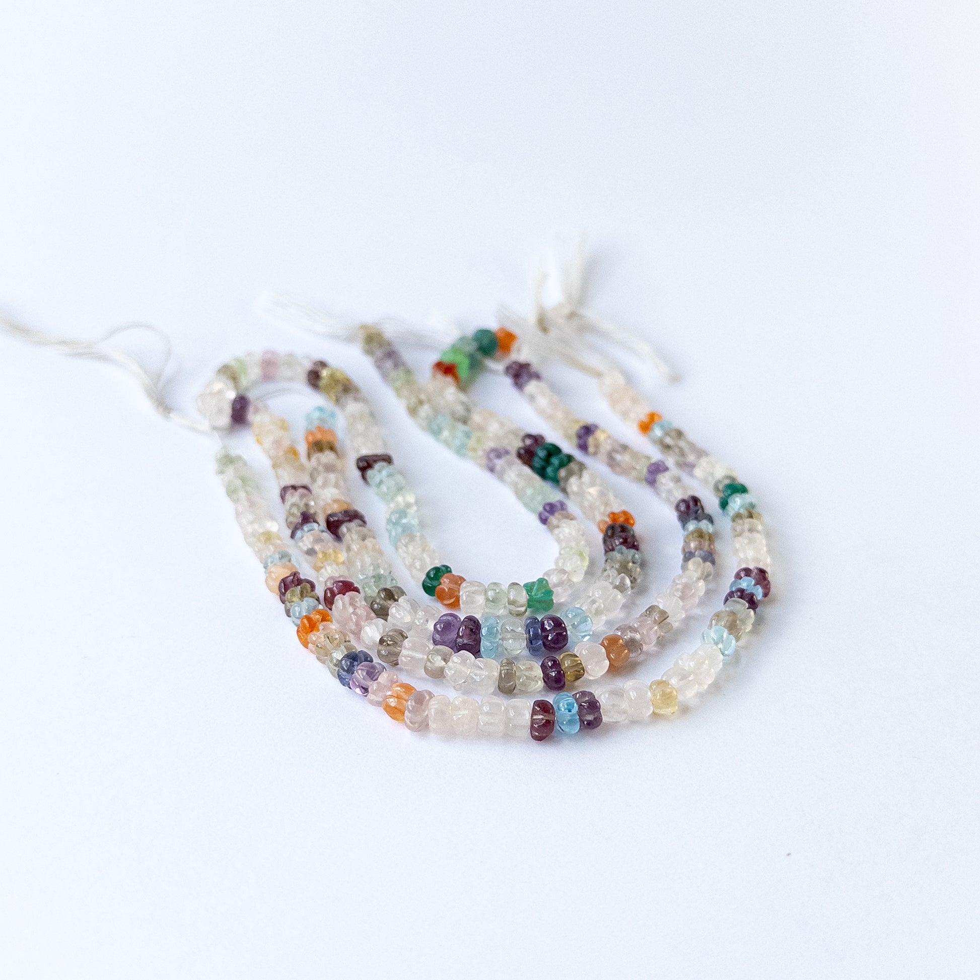 Genuine multi stone beads in carved pumpkin shape showcasing natural colours and smooth polish.