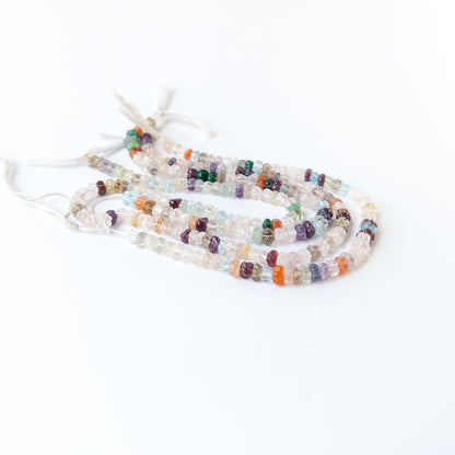 Close‑up of multi stone carved pumpkin beads showing detailed carving and natural gemstone shine.