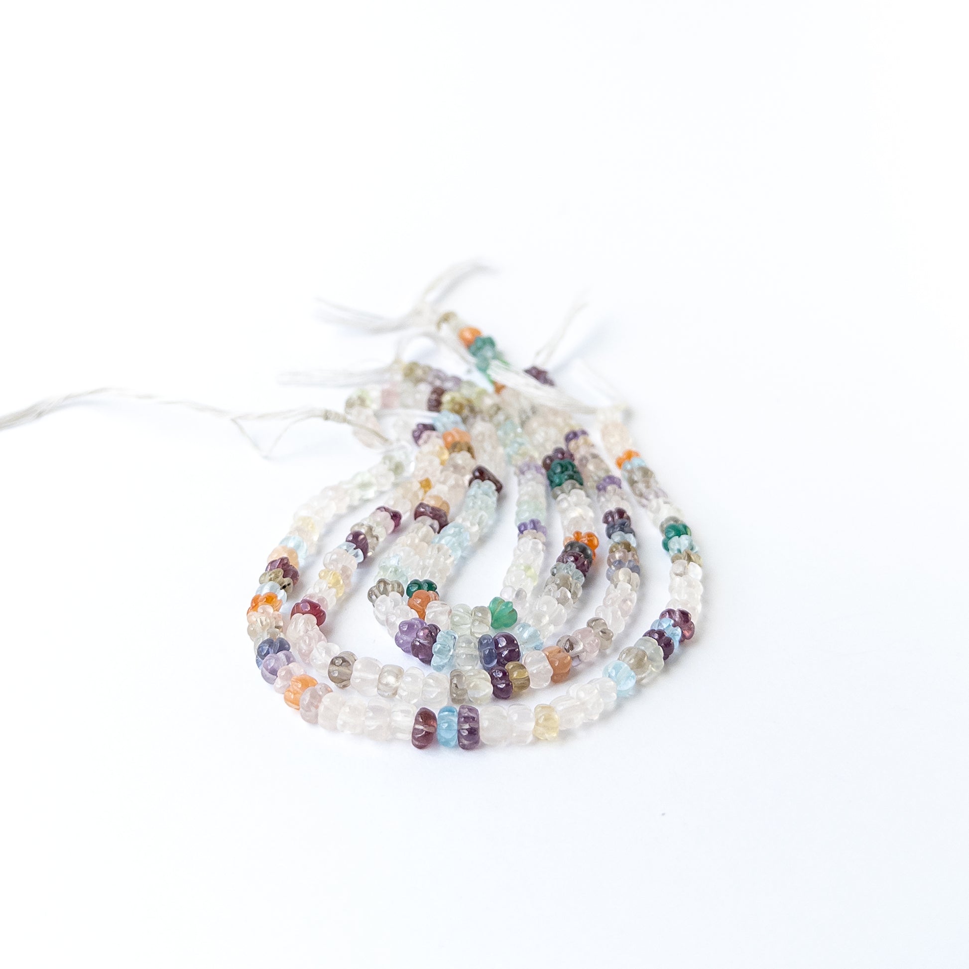 Handmade jewellery components featuring multi stone carved pumpkin beads with vibrant mixed hues.