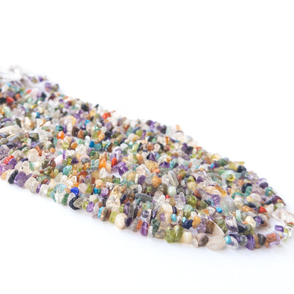 Handmade jewellery components featuring smooth multi‑stone chip beads in a neatly arranged strand.