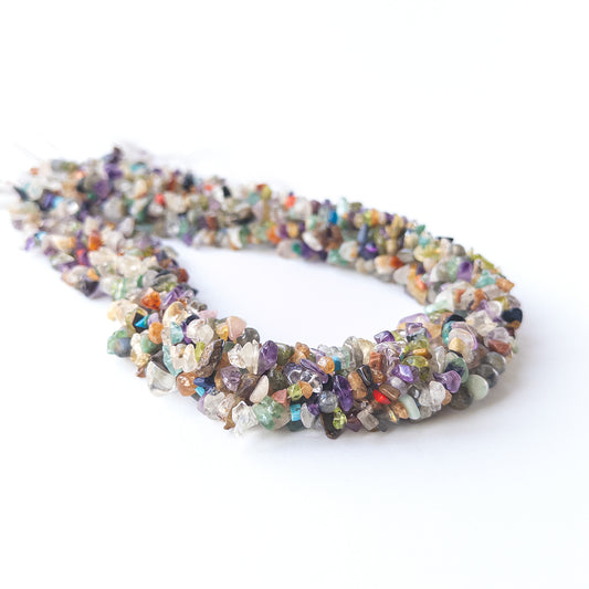 Close‑up of genuine multi‑stone chip beads showing polished shine and natural mixed gemstone tones.