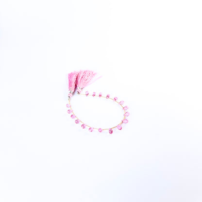 Pink Topaz faceted briolette beads showing vibrant pink colour and sparkling cut, ideal for handmade jewellery components.