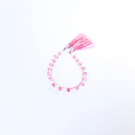 Authentic Pink Topaz gemstone beads arranged in a neat strand, highlighting their clarity and refined finish.