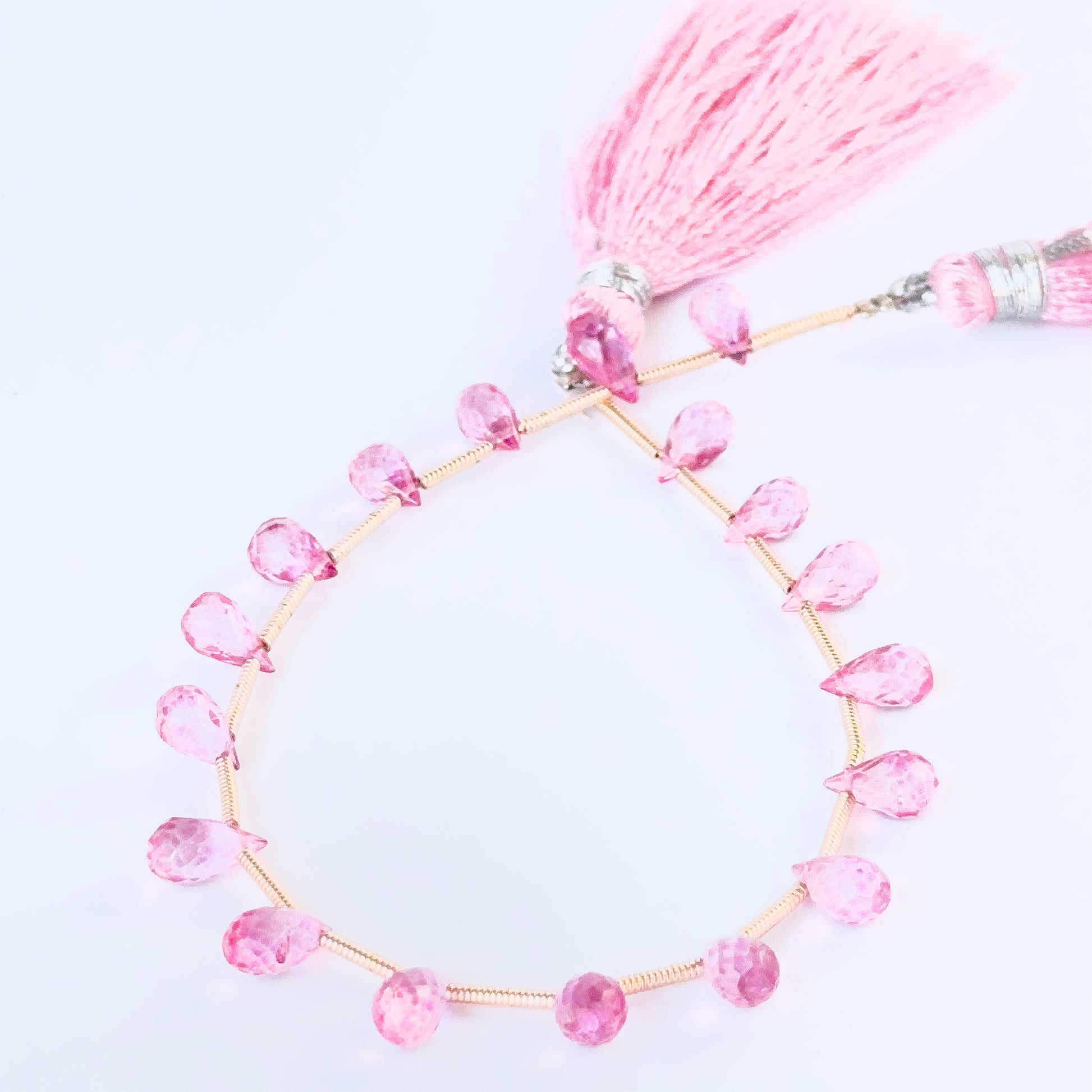 Smoothly faceted Pink Topaz briolettes with vivid colour and elegant drop shape for artisan jewellery designs.

