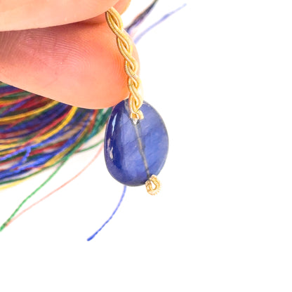 Smooth Oval Sapphire Bead in a person's hand