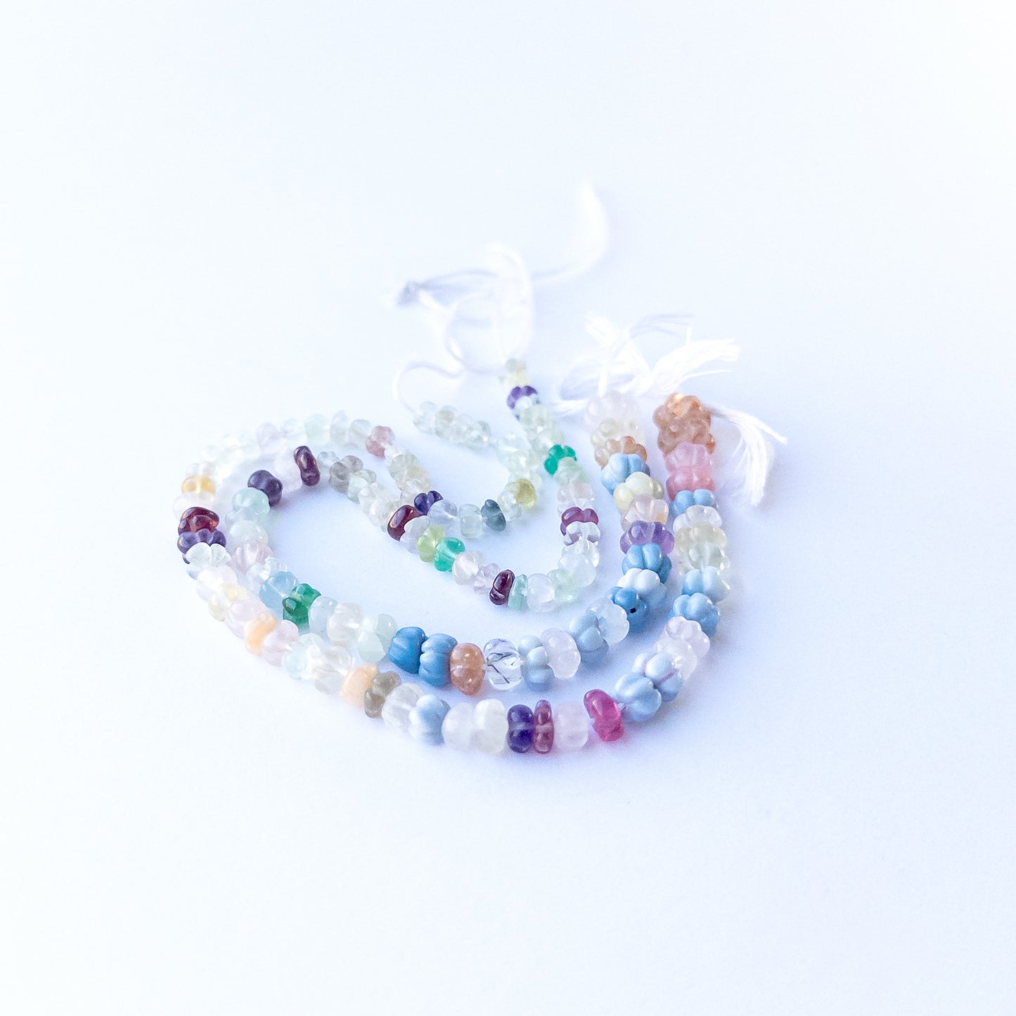 Genuine multi‑stone pumpkin cut gemstone beads showing pastel, golden and purple tones for handmade jewellery.