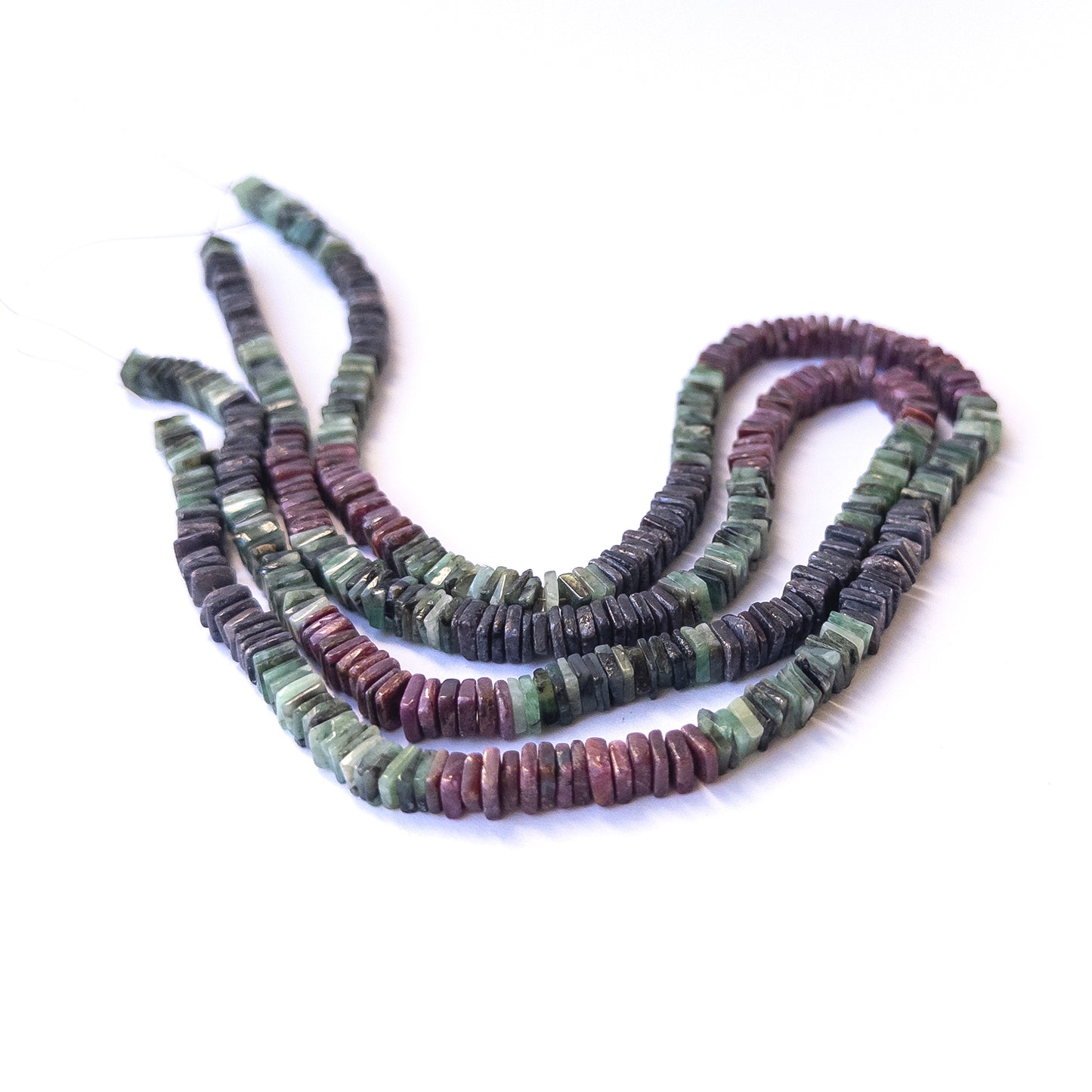 Authentic multi‑stone gemstone beads featuring rich red, blue and green tones in smooth square heishi cut.