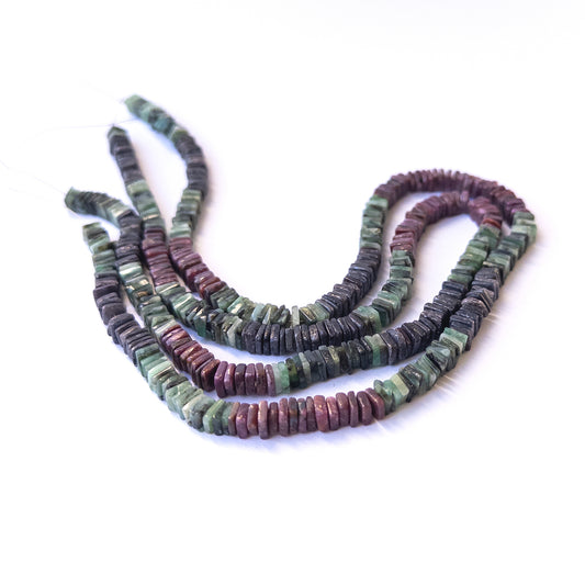 Authentic multi‑stone gemstone beads featuring rich red, blue and green tones in smooth square heishi cut.