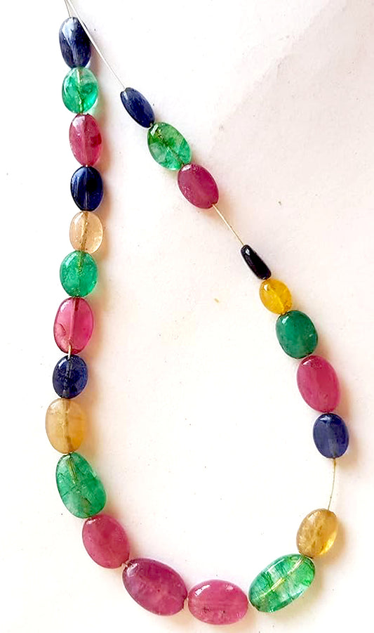 Smooth oval multi stone beads with ruby, blue sapphire, and emerald in vibrant hues and glossy 6-7mm finish.