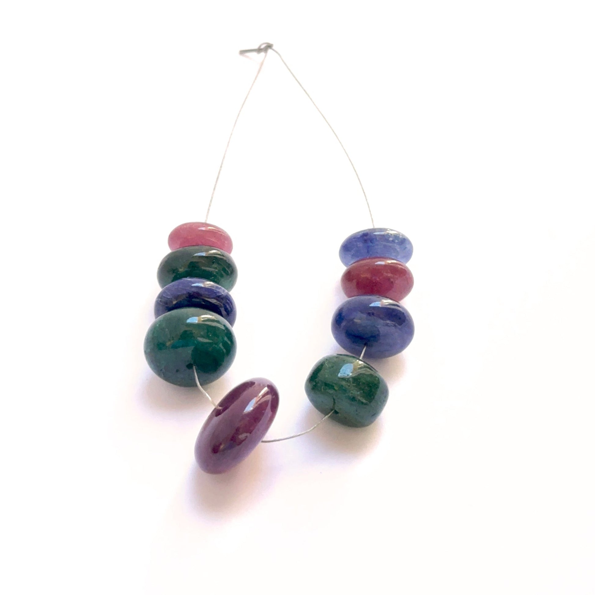 Multi stone smooth rondelle beads featuring blue sapphire, ruby and emerald 9–15mm, 9 pieces, 82 carats.