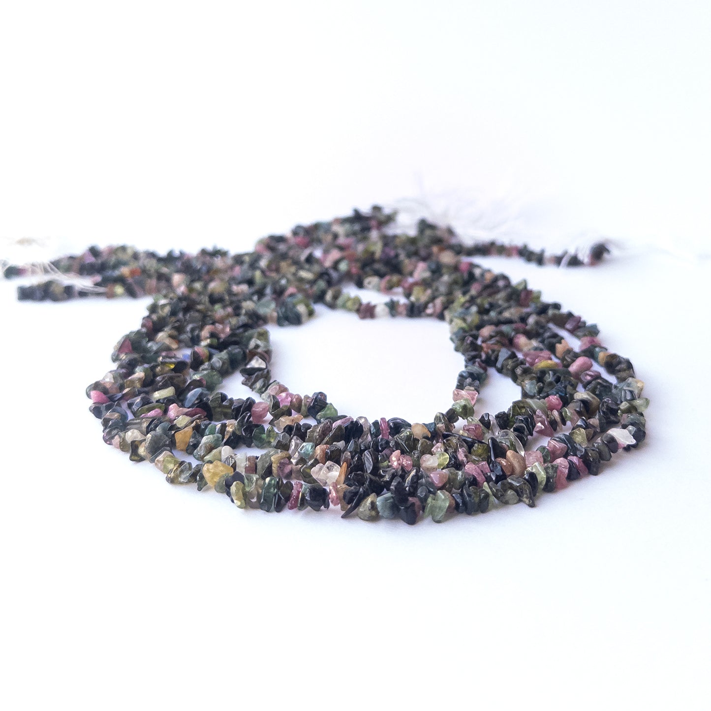 Genuine Multi Tourmaline stone beads showcasing mixed hues and organic chip shapes with polished shine.