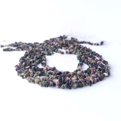 Genuine Multi Tourmaline stone beads showcasing mixed hues and organic chip shapes with polished shine.