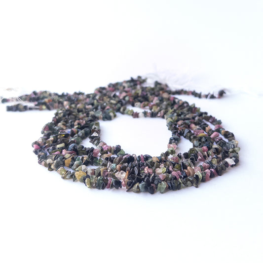Genuine Multi Tourmaline stone beads showcasing mixed hues and organic chip shapes with polished shine.