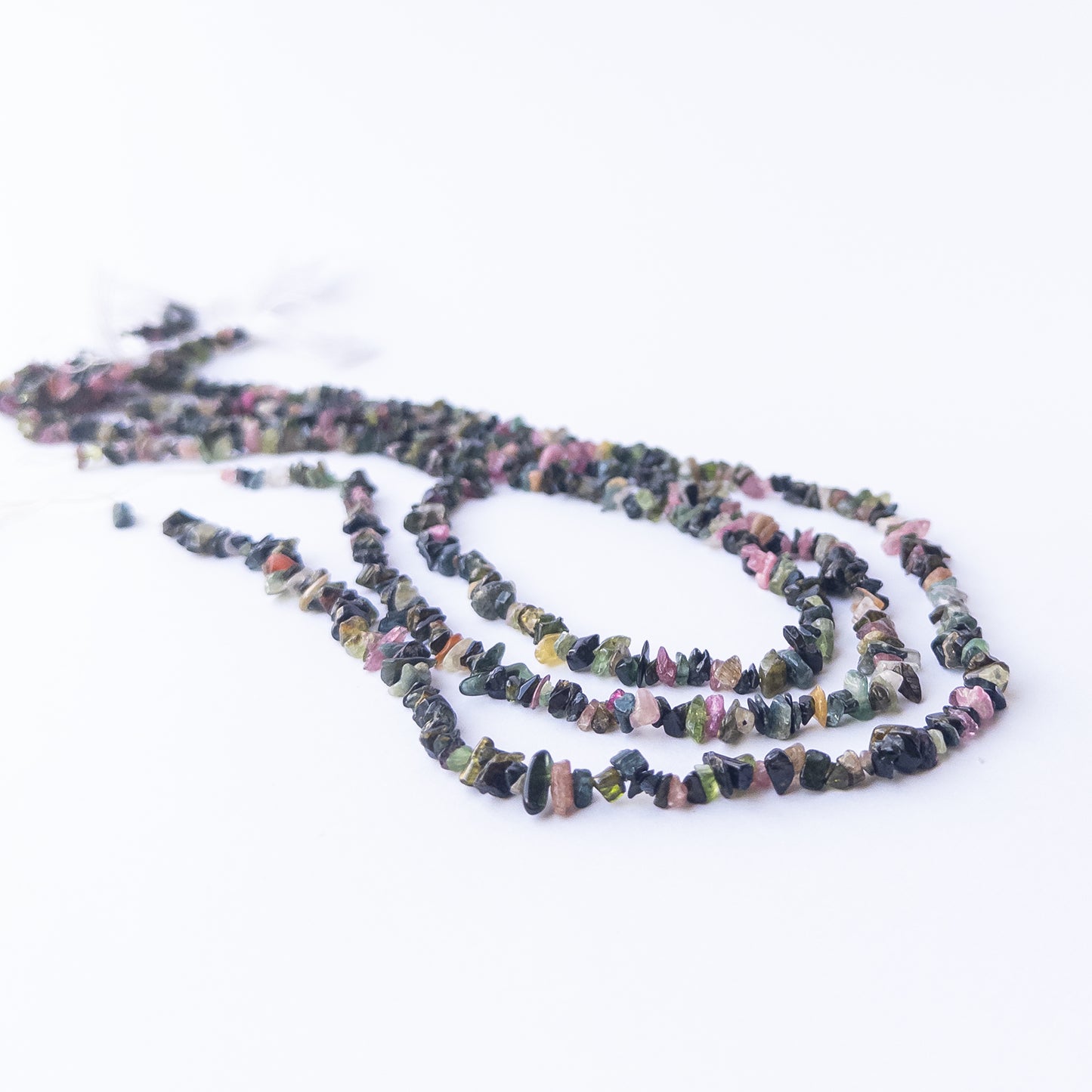Close‑up of Multi Tourmaline chip beads showing their sparkle, clarity, and unique organic arrangement.