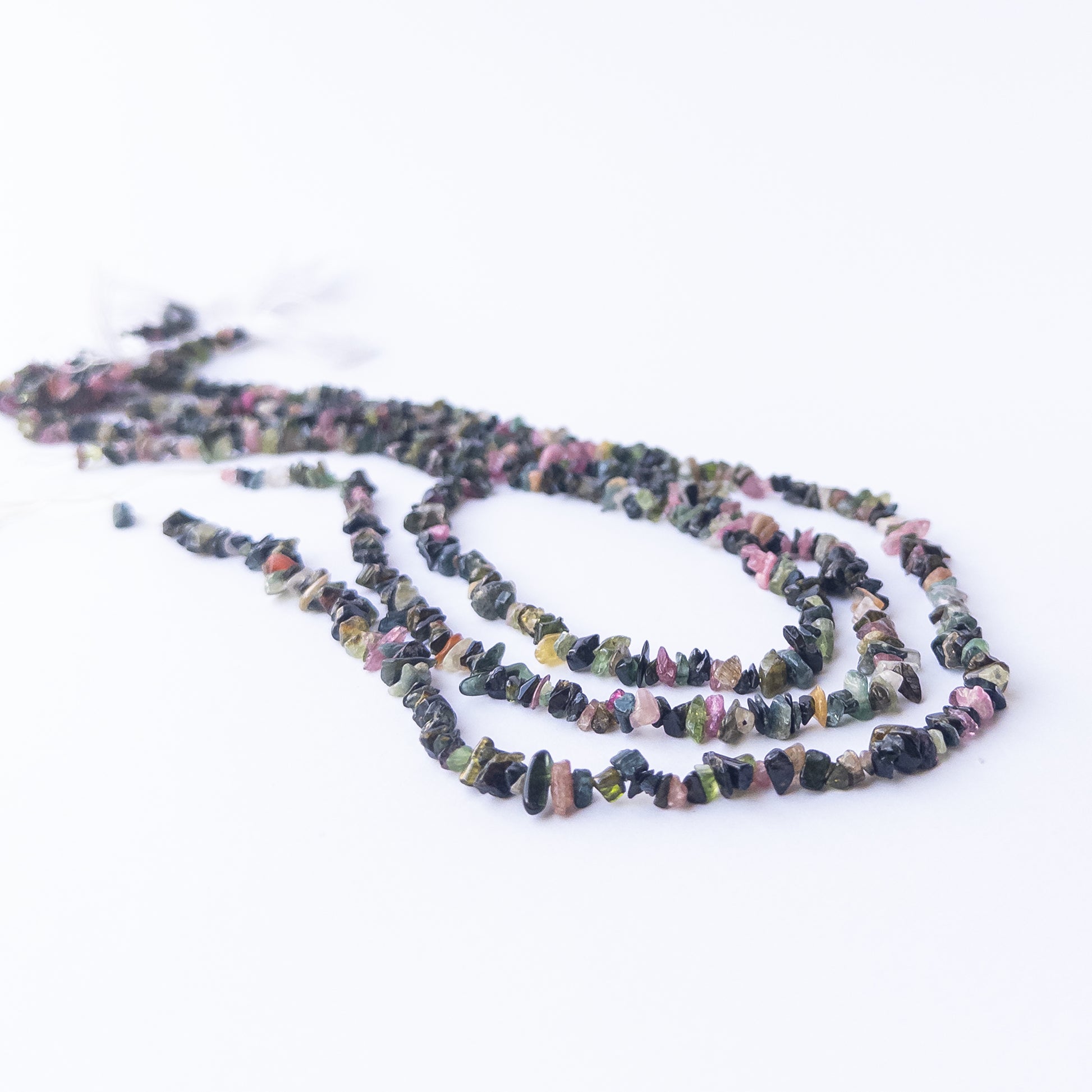 Close‑up of Multi Tourmaline chip beads showing their sparkle, clarity, and unique organic arrangement.