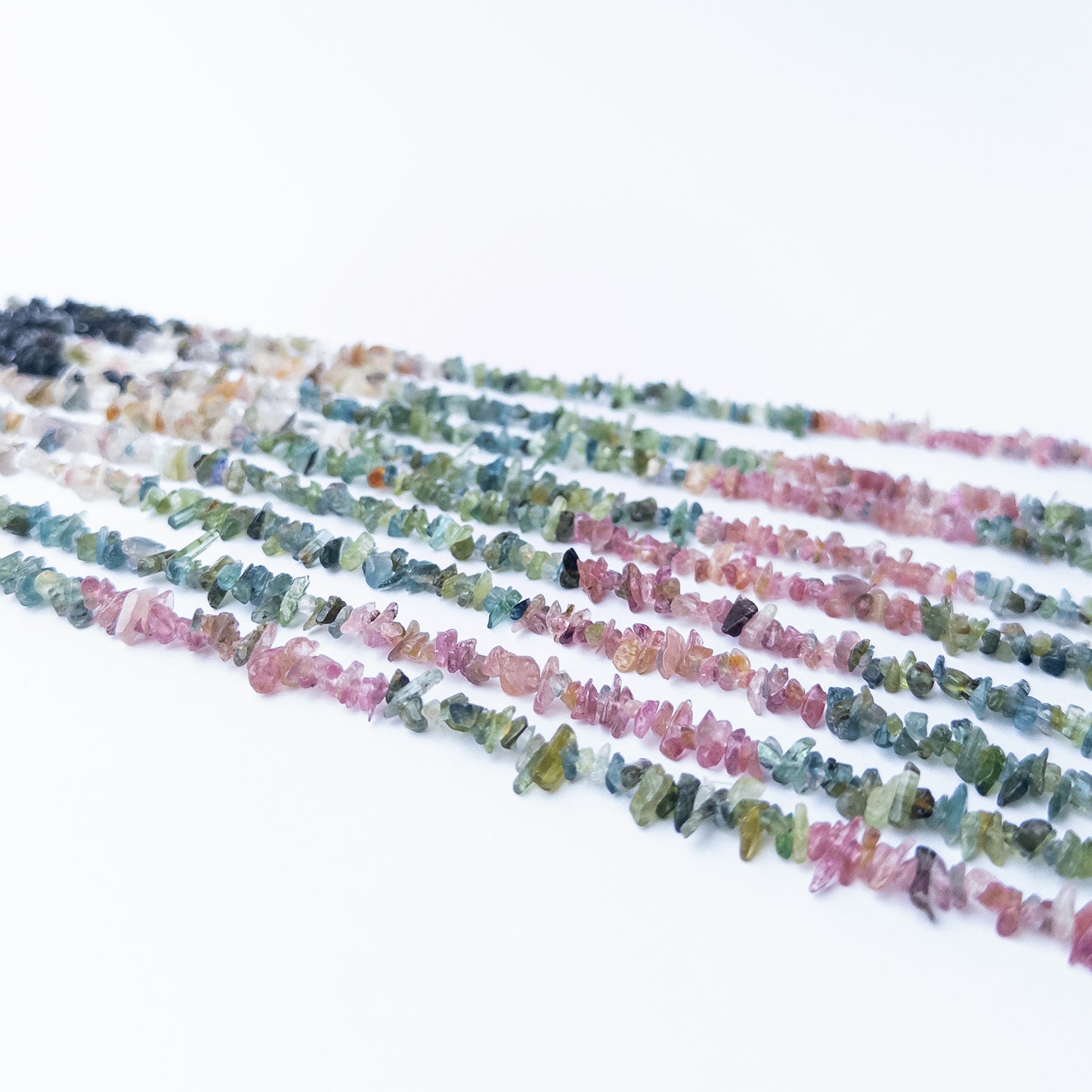 Close‑up of Multi Tourmaline chip beads showing their sparkle, clarity, and unique organic arrangement.
