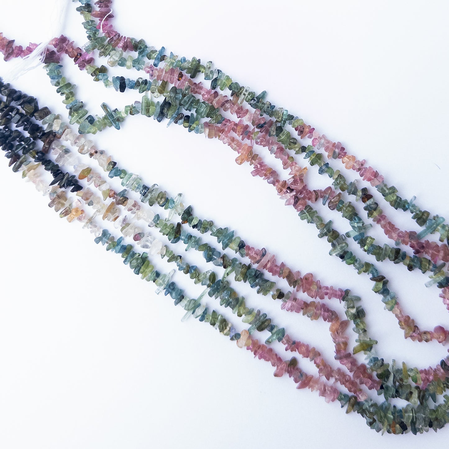 Multi Tourmaline chip and nugget gemstone beads arranged in a colourful 35cm strand for DIY jewellery.