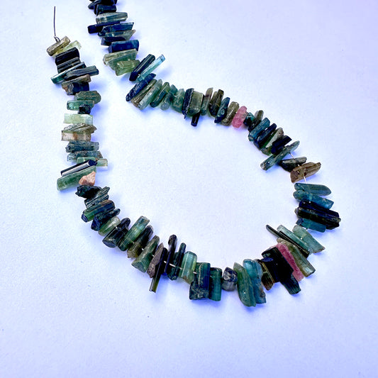 Multi Tourmaline side drilled rough beads in mixed pink, green, and earthy tones on a 23cm strand for jewellery making.