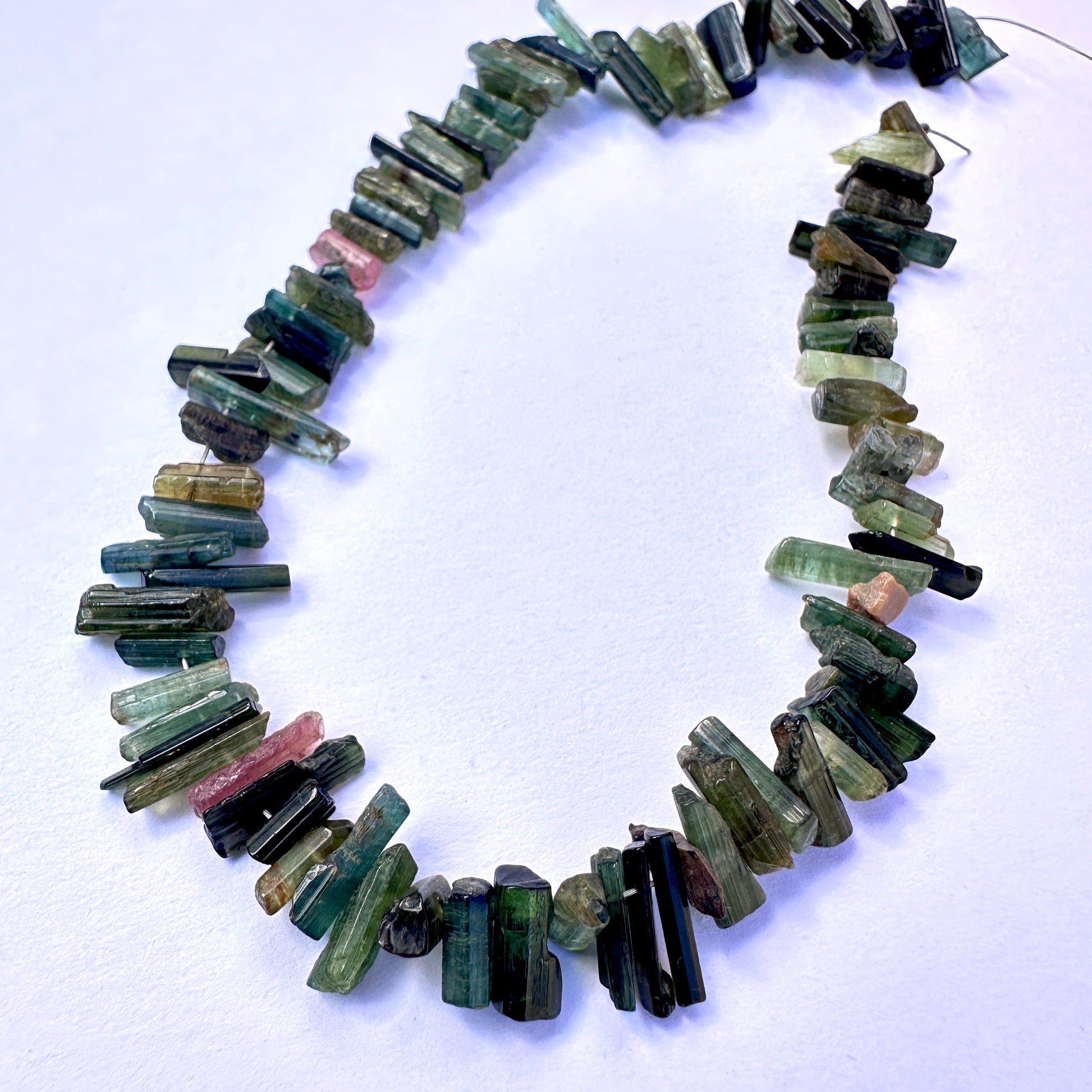 A dial gauge measures the Multi Tourmaline side drilled rough 3.7-4.5mm gemstone.