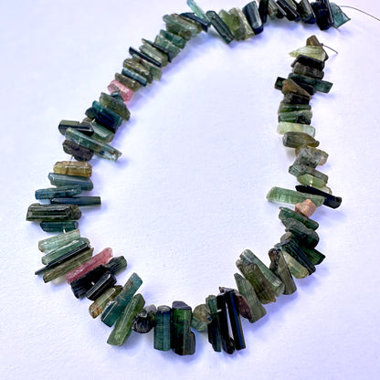 A dial gauge measures the Multi Tourmaline side drilled rough 3.7-4.5mm gemstone.