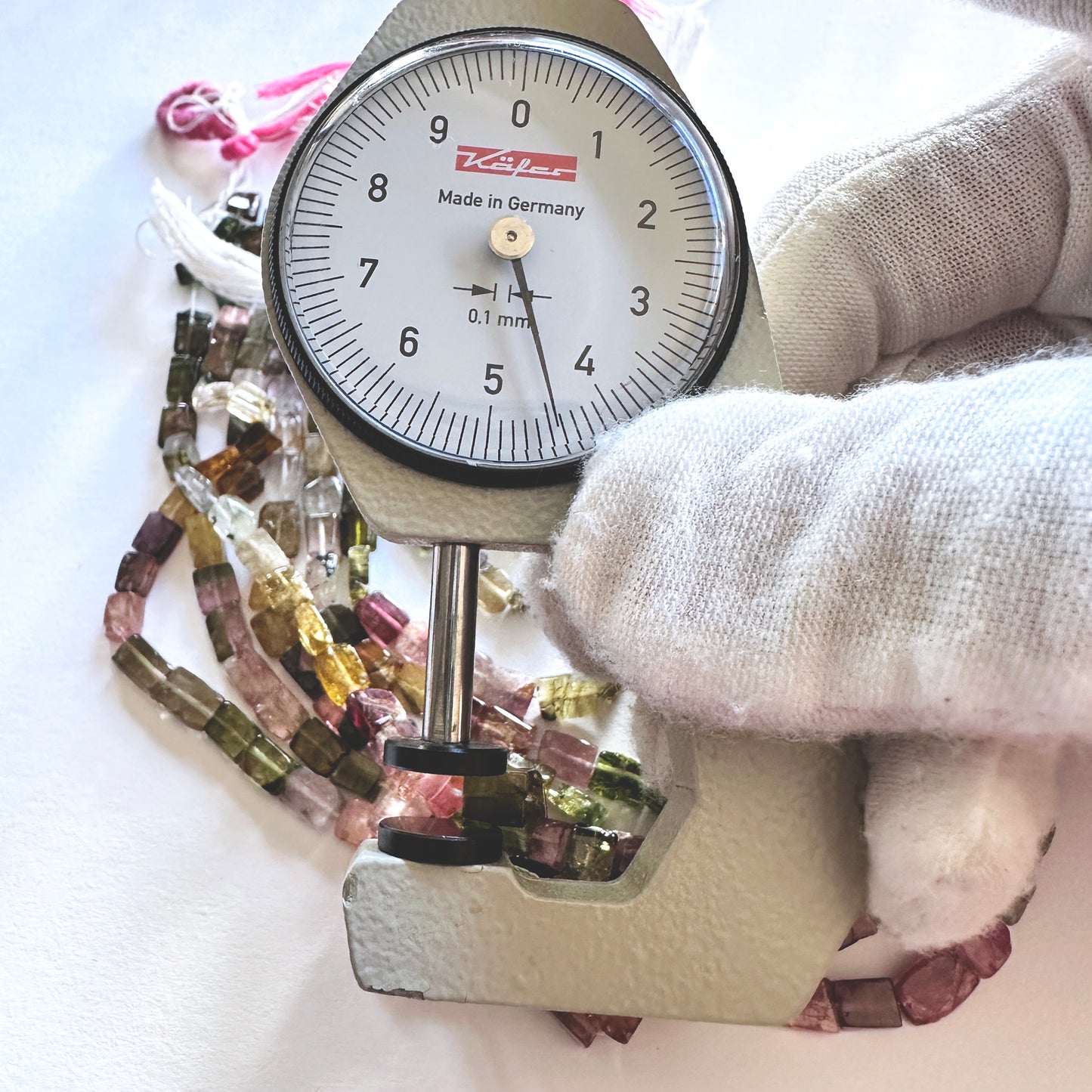 A dial gauge measures the Multi Tourmaline smooth rectangle 4.5mm gemstone.