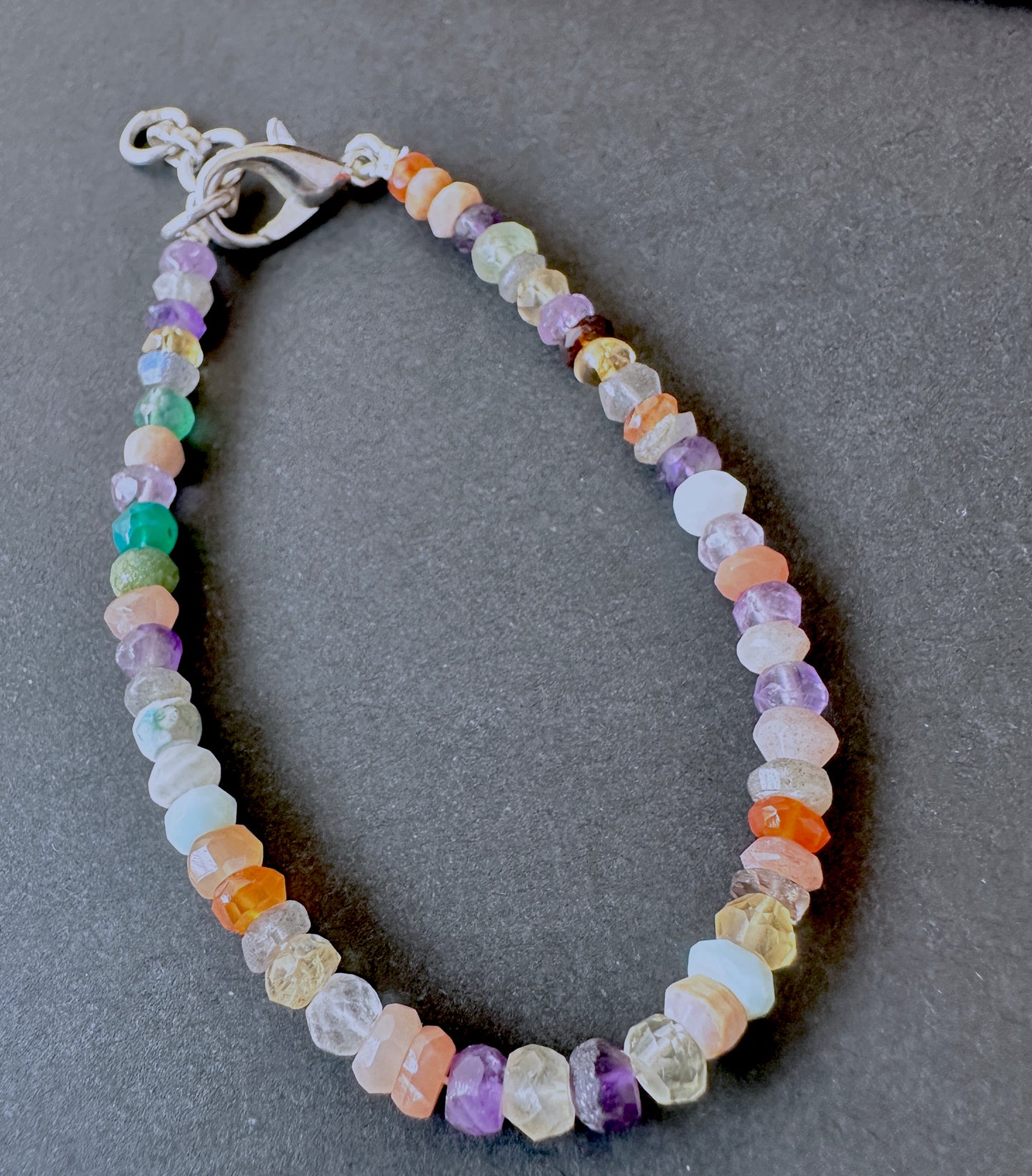 Elegant multi gemstone bracelet crafted from natural gemstone beads, 4.3–4.5mm faceted rondelles, adjustable 17.5cm length.