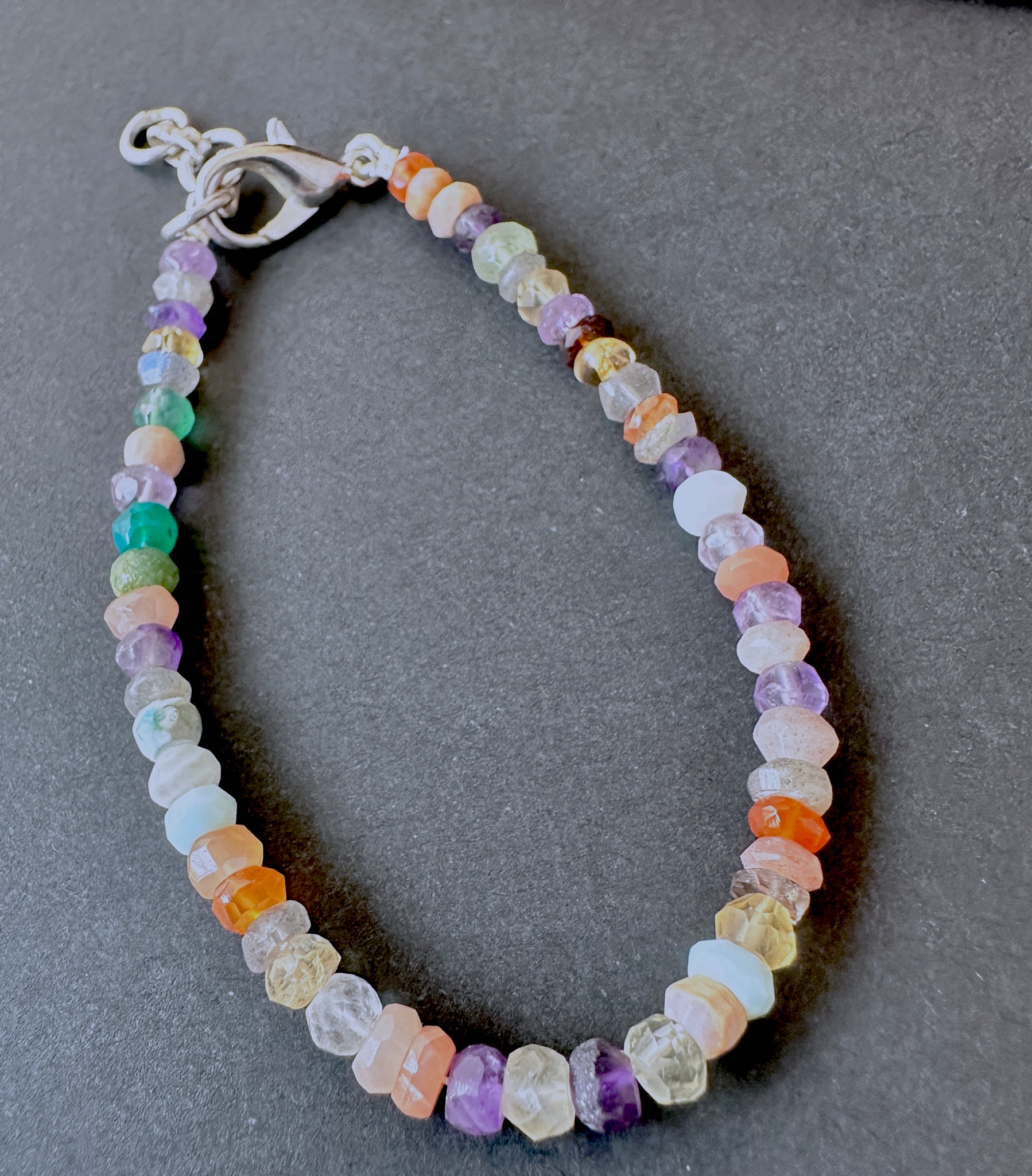 Elegant multi gemstone bracelet crafted from natural gemstone beads, 4.3–4.5mm faceted rondelles, adjustable 17.5cm length.