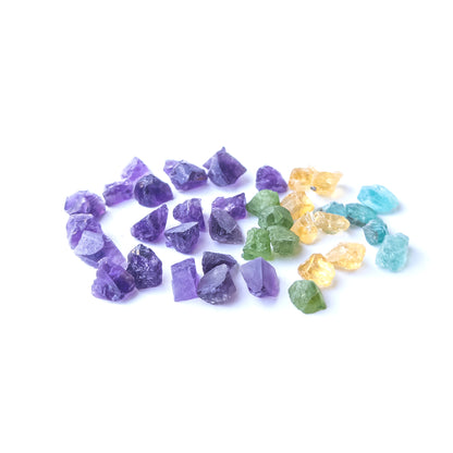 Mixed Amethyst, Citrine, Apatite and Peridot rough stones arranged together with vivid colour contrast.