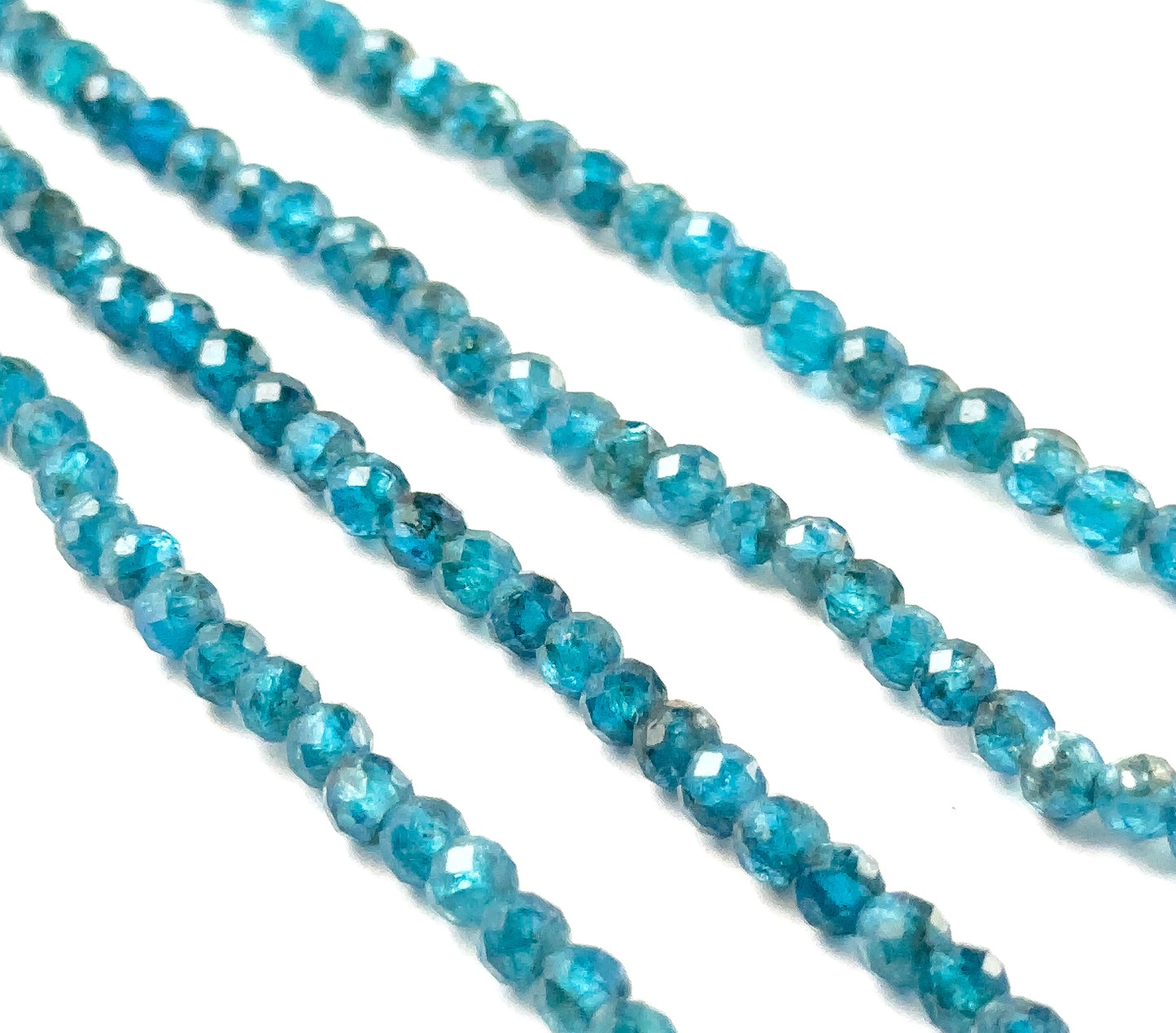 Neon Apatite faceted rondelle gemstones with crisp faceting and intense neon‑blue tones across a 32cm strand.