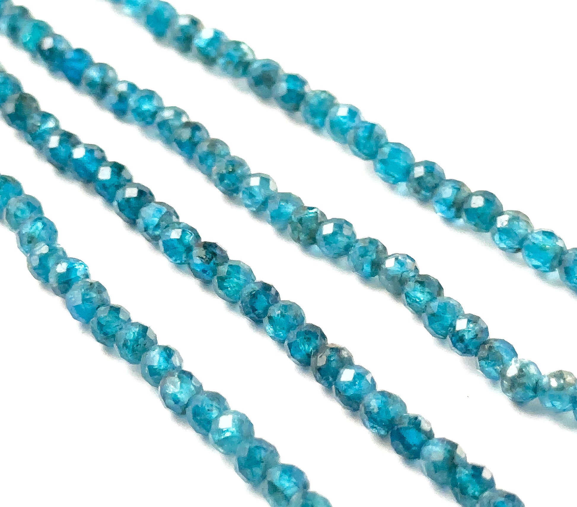 Neon Apatite faceted rondelle gemstones with crisp faceting and intense neon‑blue tones across a 32cm strand.