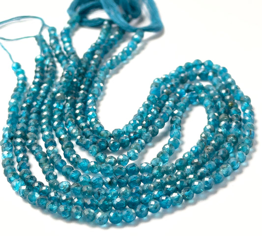 Neon Apatite smooth faceted rondelle beads sized 3.5–3.7mm arranged in a 32cm strand, showing vivid electric‑blue colour and bright sparkle.