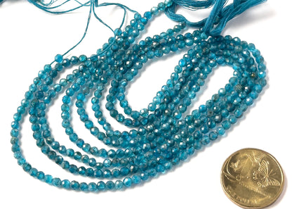 A coin is placed near Neon Apatite faceted rondelle beads to show the 3.5–3.7mm size range.