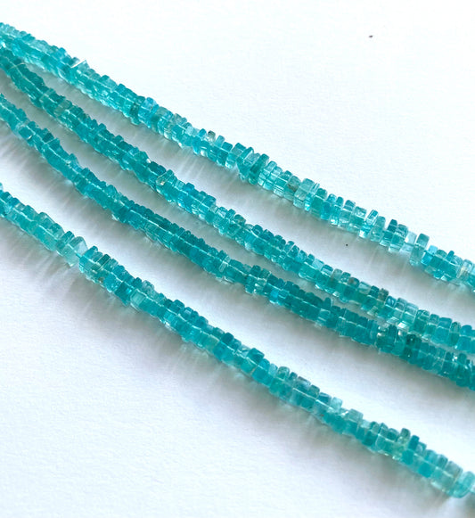 Close-up of smooth Neon Apatite square beads showing their 4.5–5.5mm size and polished finish.