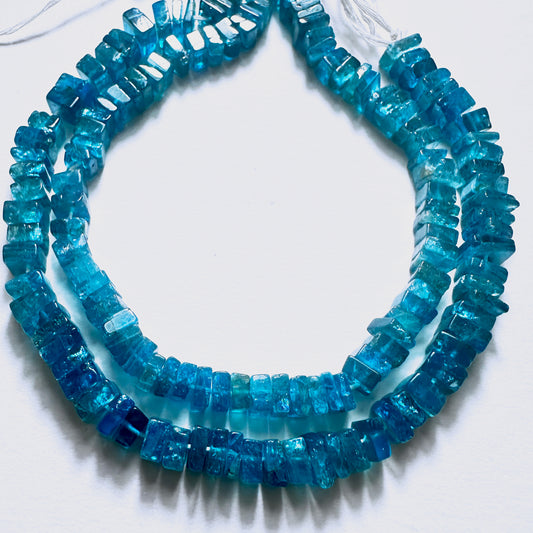 Close-up of Neon Apatite stone beads in square heishi cut, arranged on a 19cm strand for DIY jewellery designs.
