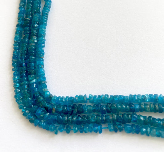 Neon apatite smooth wheel beads in bright blue tones, displayed in 30cm and 34cm strand options.