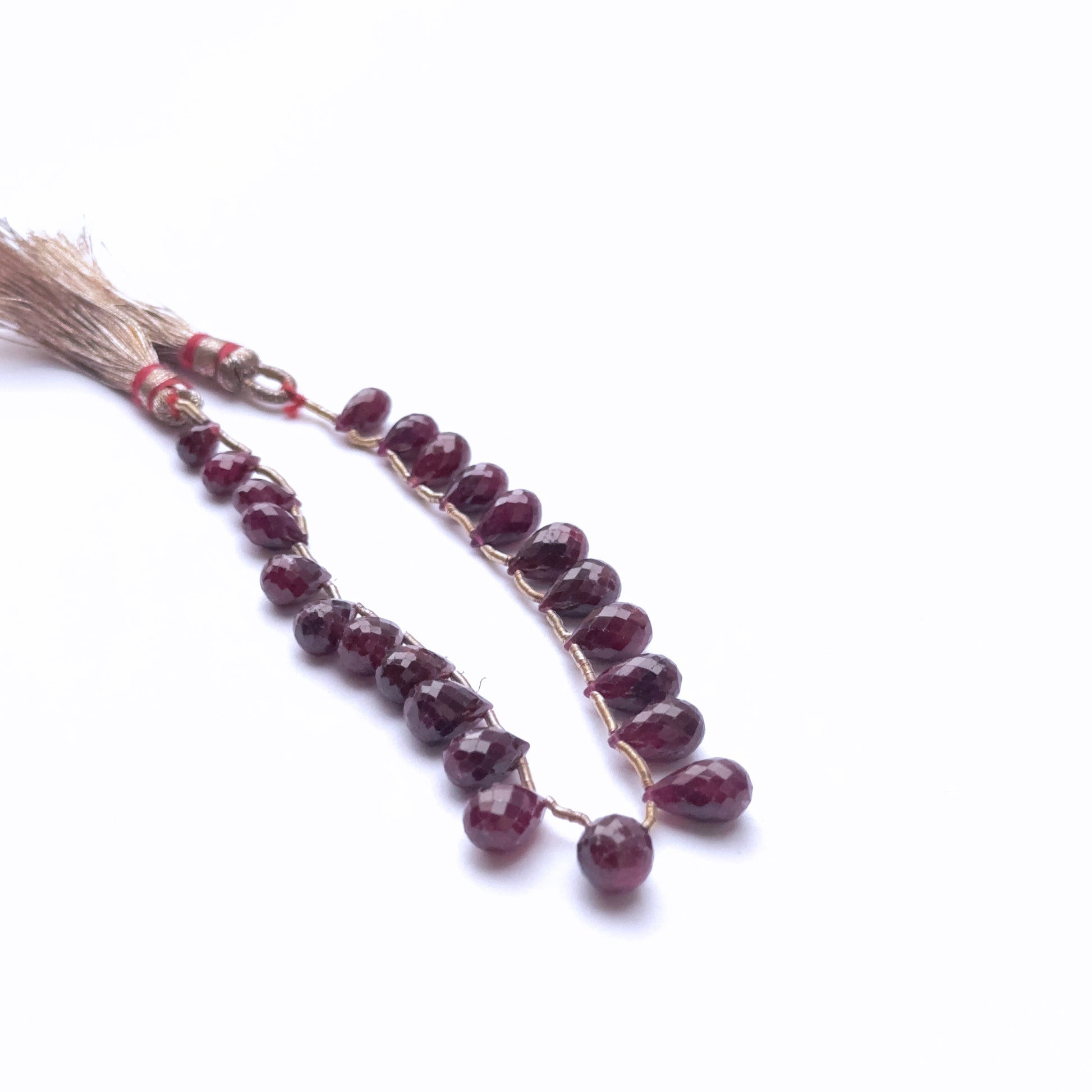 Handmade jewellery components featuring ruby teardrops in vibrant tones.